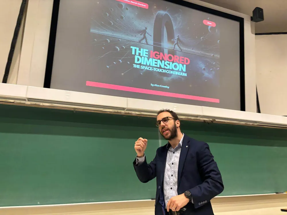 Alan gesturing in front of a slide titled The Ignored Dimension: The Space-Touch Continuum
